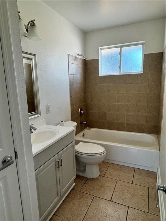 full bathroom with tile patterned floors, toilet, vanity, and tiled shower / bath