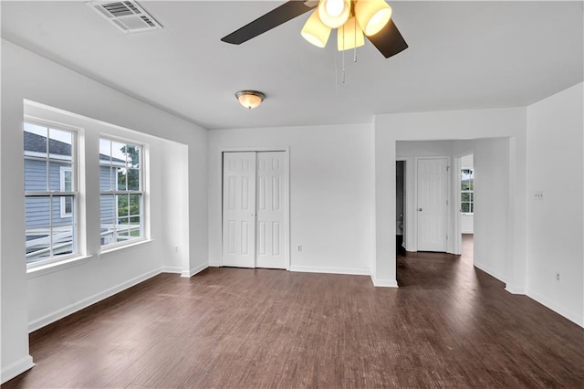 spare room featuring dark hardwood / wood-style floors and ceiling fan