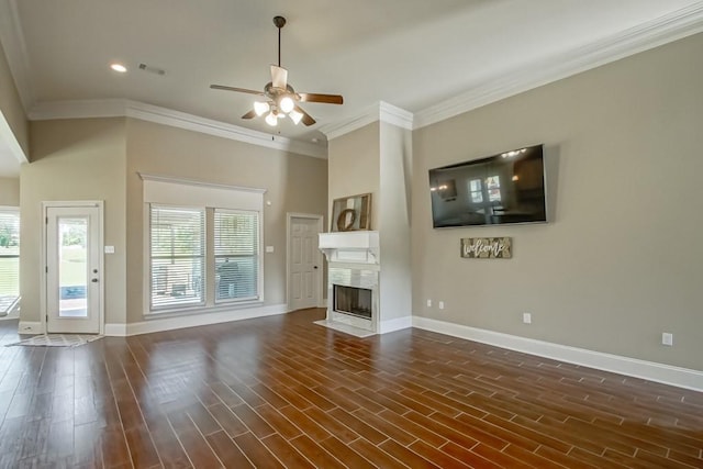 unfurnished living room with dark wood-style floors, a premium fireplace, and baseboards