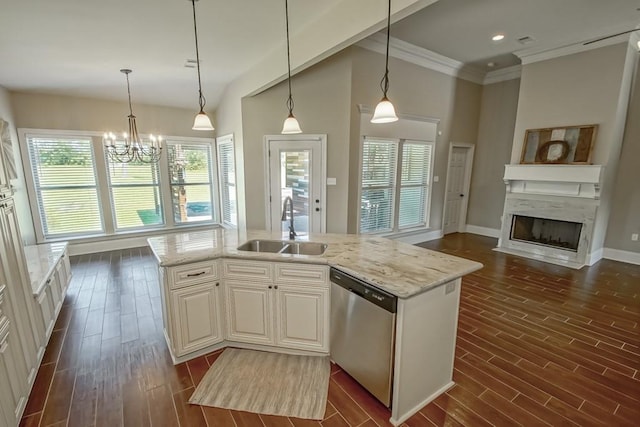 kitchen with a sink, a kitchen island with sink, dishwasher, and hanging light fixtures