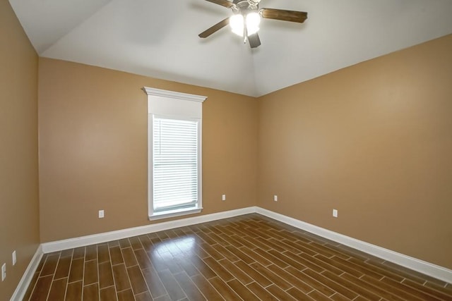 unfurnished room featuring lofted ceiling, ceiling fan, dark wood finished floors, and baseboards