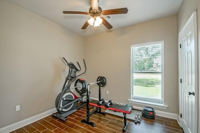 exercise area featuring baseboards, a ceiling fan, and wood finish floors