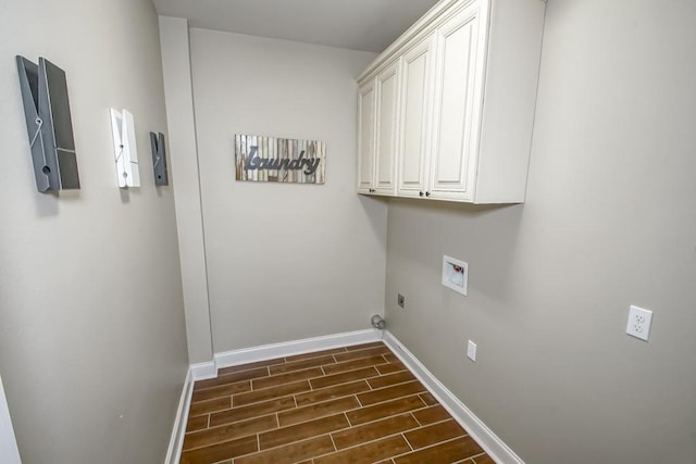 laundry room featuring cabinet space, baseboards, hookup for a washing machine, hookup for an electric dryer, and wood finish floors