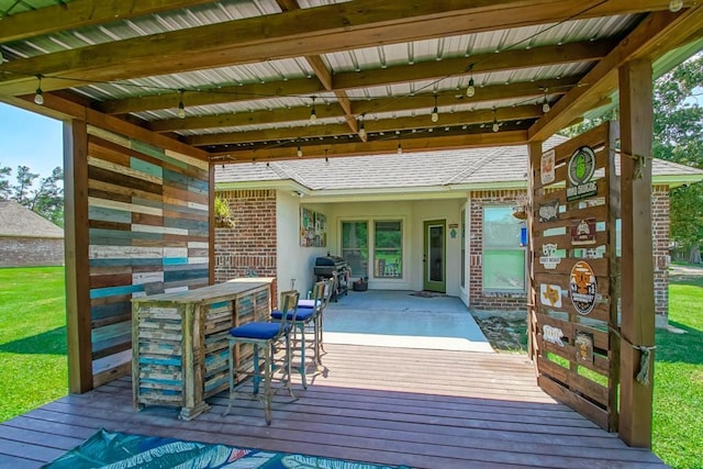 deck featuring outdoor dry bar, a patio area, and grilling area