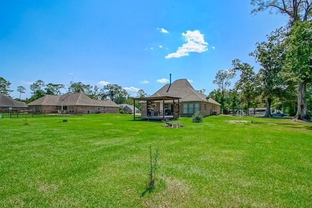 rear view of house featuring a lawn