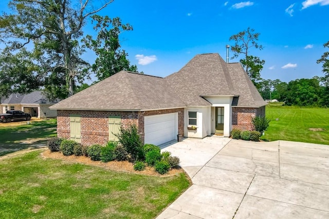 view of front of property with a garage, a shingled roof, a front yard, and brick siding