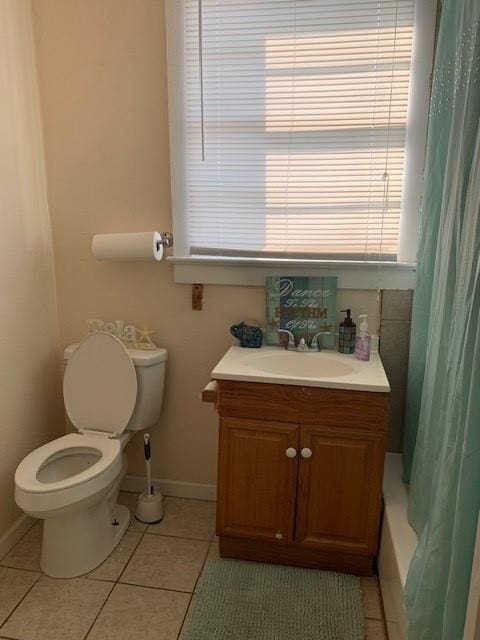 full bathroom with tile patterned flooring, vanity, shower / tub combo with curtain, and toilet