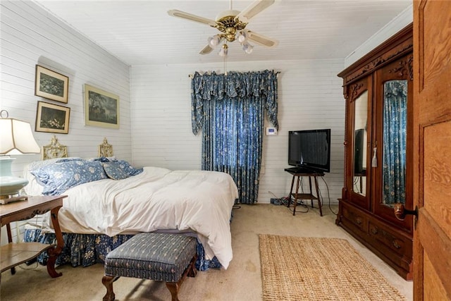 carpeted bedroom with ornamental molding and ceiling fan