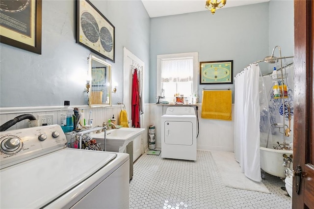 laundry area with washing machine and dryer and light tile patterned flooring