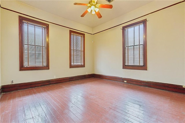 empty room with wood-type flooring, plenty of natural light, and ceiling fan