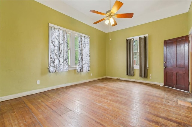 spare room featuring ceiling fan, plenty of natural light, and light hardwood / wood-style floors