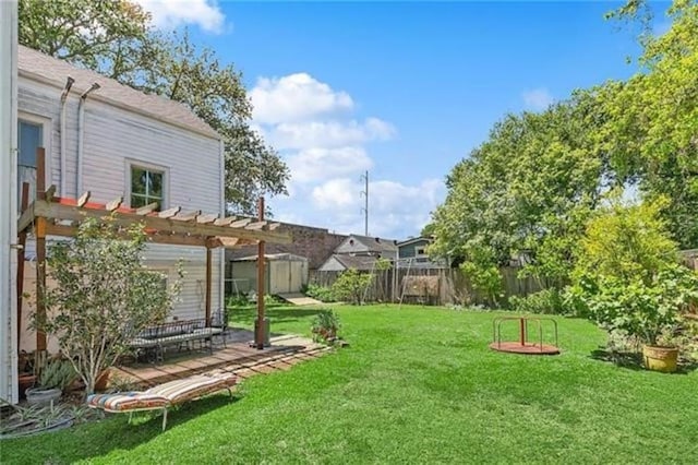 view of yard featuring a pergola and a storage unit