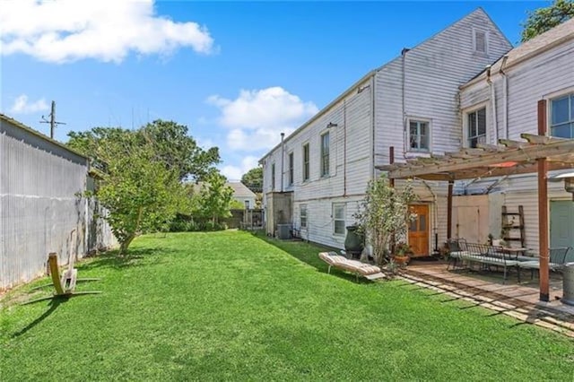 view of yard with a patio, central AC unit, and a pergola