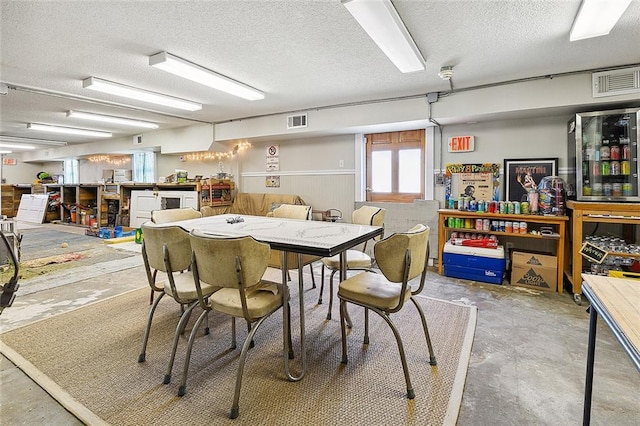 dining area with concrete floors and a textured ceiling