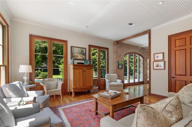 living room featuring french doors, light hardwood / wood-style floors, and ornamental molding