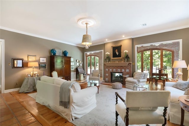 living room featuring a fireplace, french doors, and ornamental molding