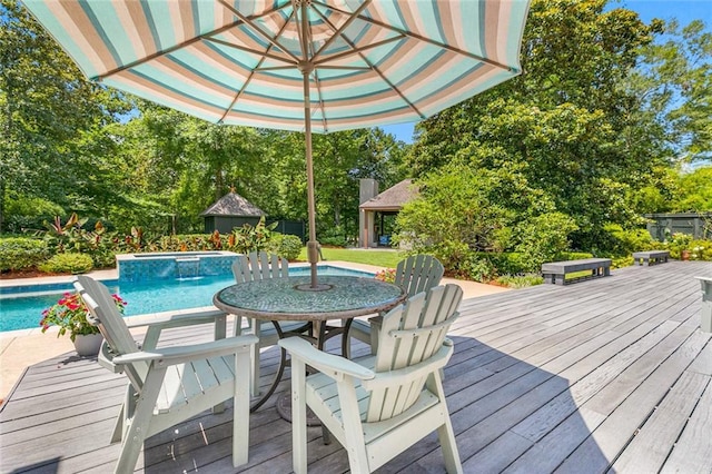 view of swimming pool with a hot tub and a deck