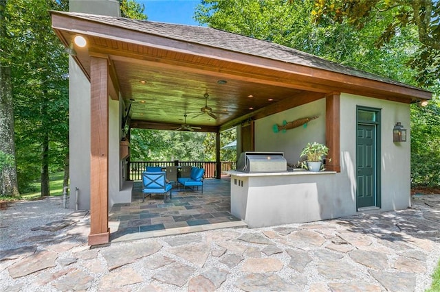 view of patio / terrace with an outdoor kitchen, ceiling fan, and a grill