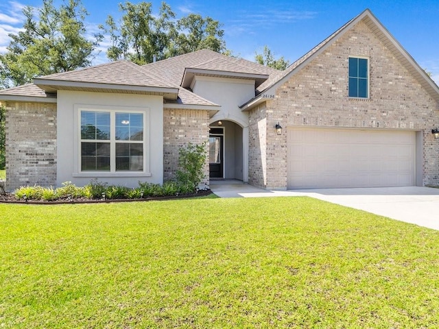 view of front of house with a garage, driveway, brick siding, and a front yard