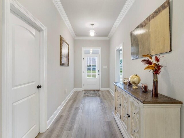 doorway with crown molding and light hardwood / wood-style flooring