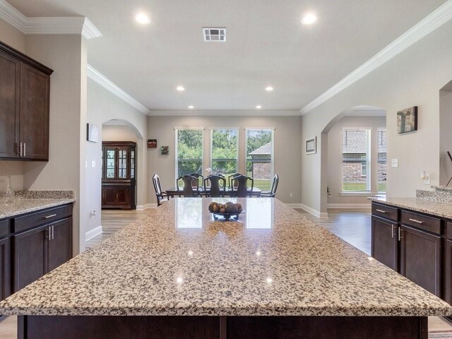 kitchen featuring a kitchen island and light stone countertops