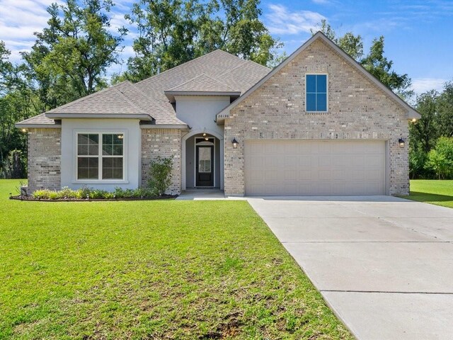 view of front of property with a garage, brick siding, concrete driveway, roof with shingles, and a front yard