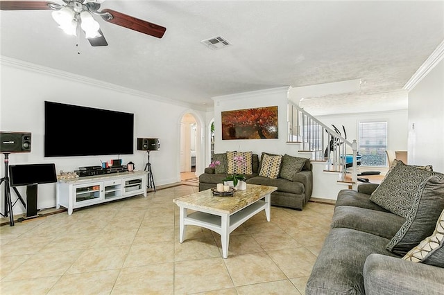 living room with ceiling fan, light tile patterned floors, and crown molding