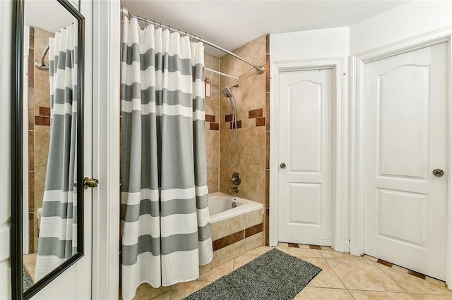 bathroom with shower / bath combo with shower curtain and tile patterned flooring