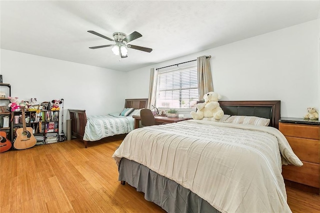 bedroom with ceiling fan and light hardwood / wood-style flooring