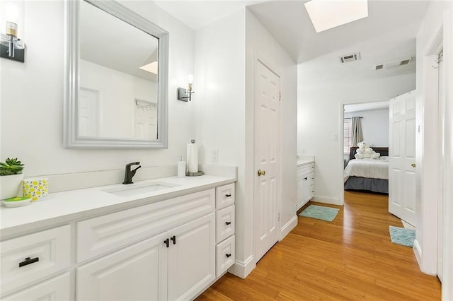 bathroom featuring hardwood / wood-style floors and vanity