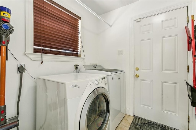 laundry room featuring separate washer and dryer and light tile patterned floors