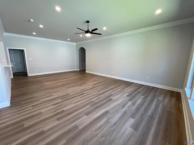 unfurnished living room with recessed lighting, arched walkways, wood finished floors, ceiling fan, and baseboards
