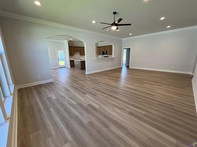 unfurnished living room with ornamental molding, ceiling fan, and hardwood / wood-style flooring