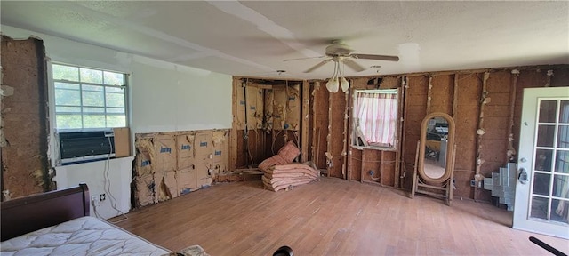 interior space with ceiling fan, hardwood / wood-style floors, and cooling unit