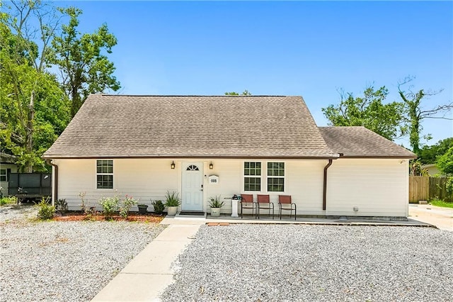 105 Fairfax Pl, New Orleans, LA 70131 - cape cod house featuring roof with shingles, covered porch, and fence