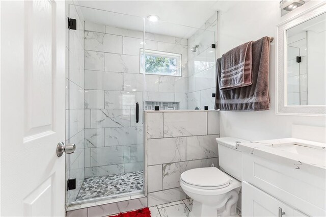 bathroom with vanity, toilet, and a shower with shower door