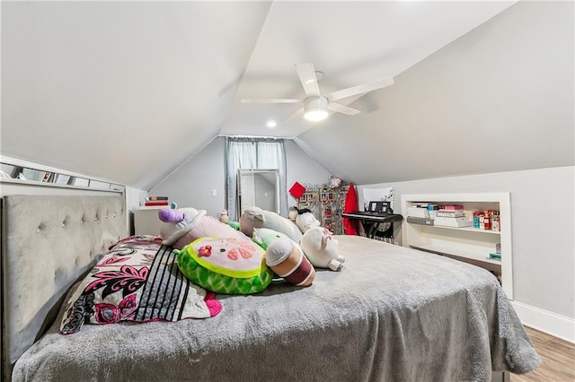 bedroom featuring wood-type flooring, lofted ceiling, and ceiling fan