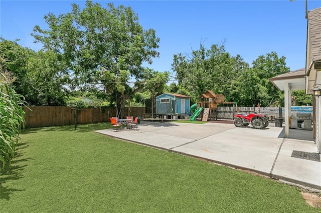 view of patio / terrace with a shed and a playground