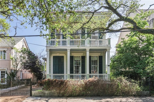 view of front of house with a porch and a balcony