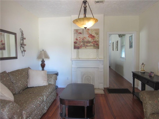8719 Fig St, New Orleans, LA 70118 - living room with hardwood / wood-style floors, a textured ceiling, and visible vents
