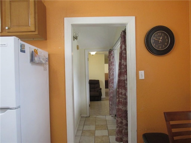 hallway featuring light tile patterned flooring