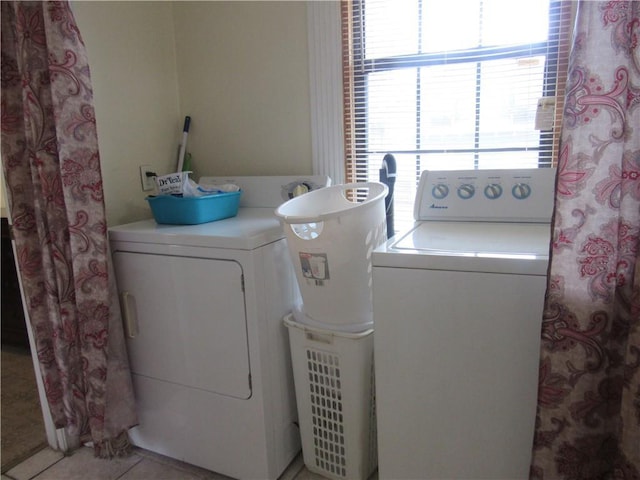 8719 Fig St, New Orleans, LA 70118 - laundry room featuring washing machine and clothes dryer, light tile patterned floors, and laundry area
