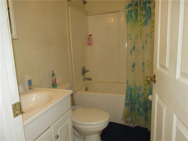 full bathroom with shower / tub combo, toilet, and vanity