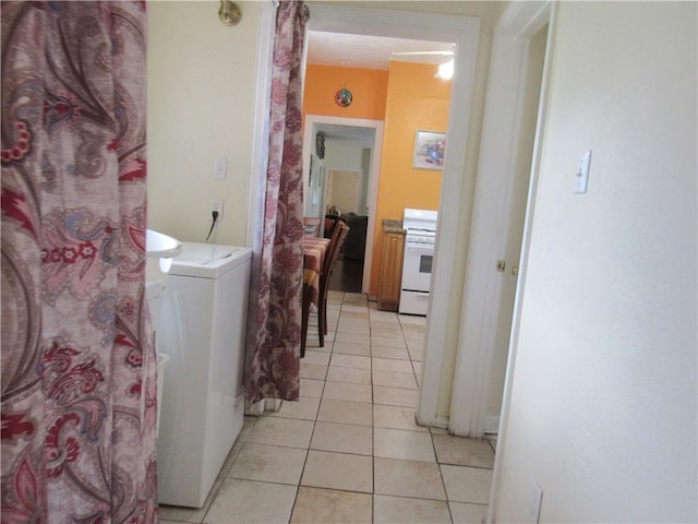 laundry area featuring light tile patterned flooring and washer / dryer