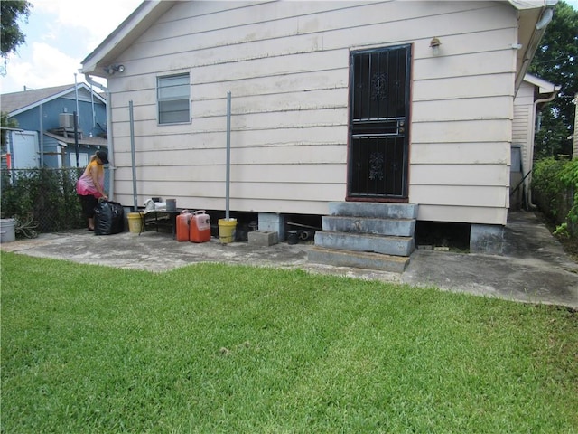 back of property featuring a lawn