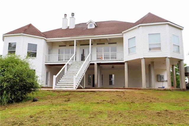 back of house featuring a yard