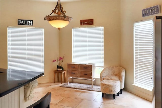 living area featuring plenty of natural light and light tile patterned floors