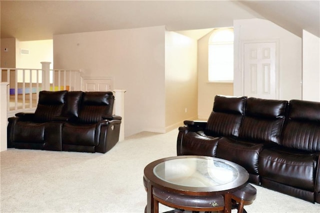 carpeted living room with lofted ceiling