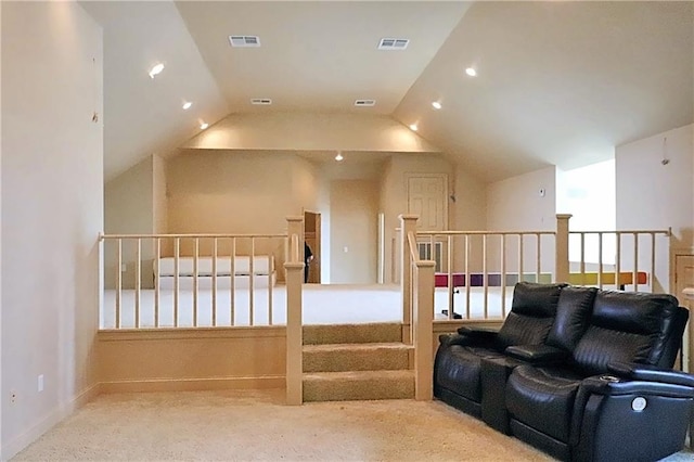 interior space with carpet flooring and vaulted ceiling