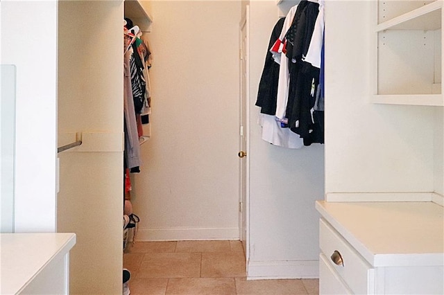 spacious closet featuring light tile patterned floors